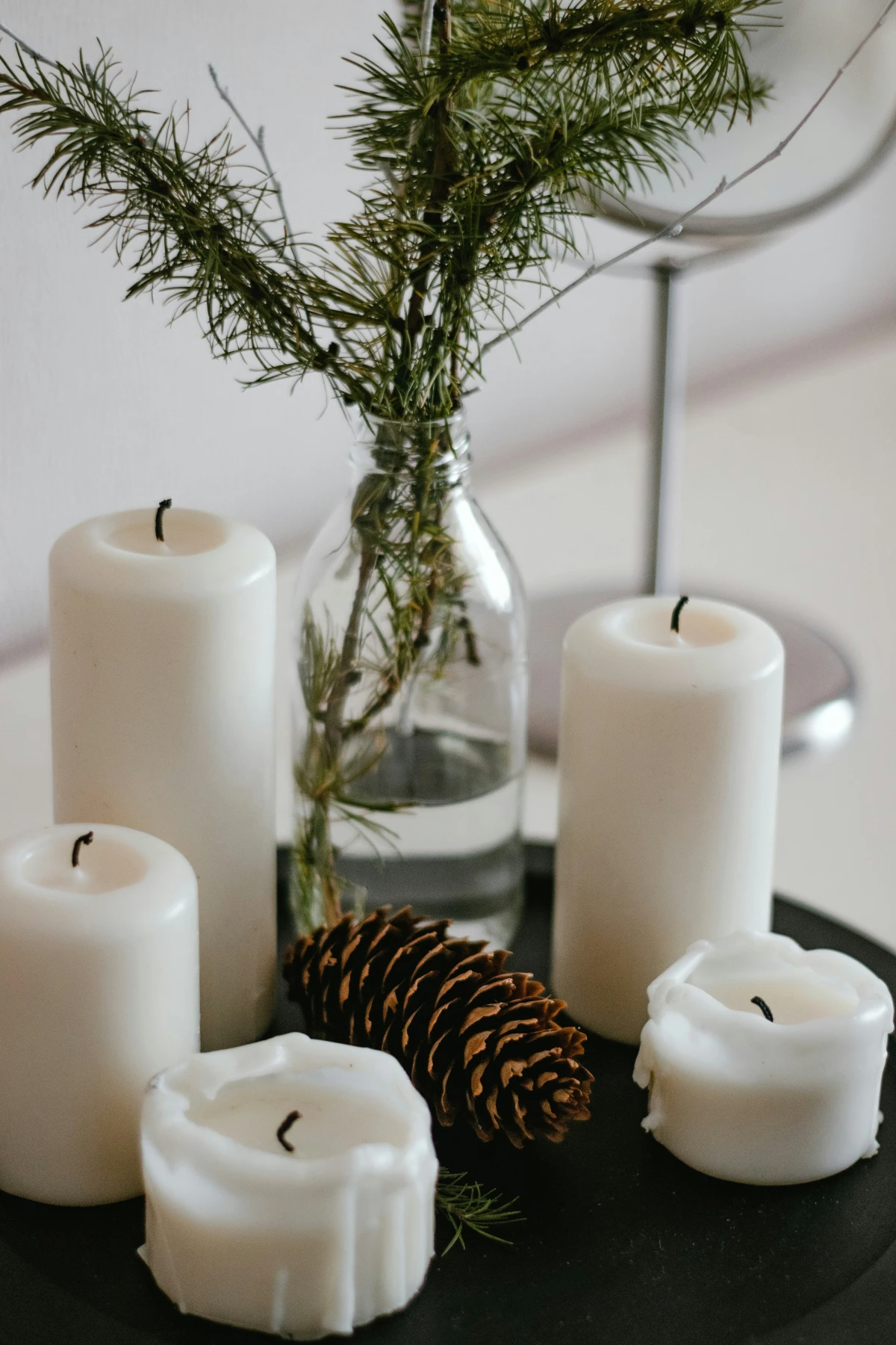 pine cone candles and evergreen boughs