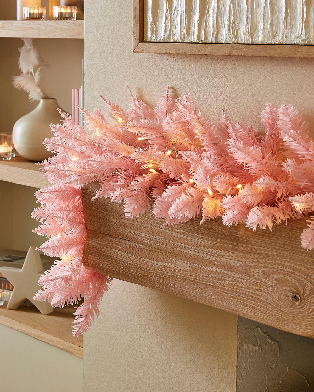 pink ornament garland on fireplace