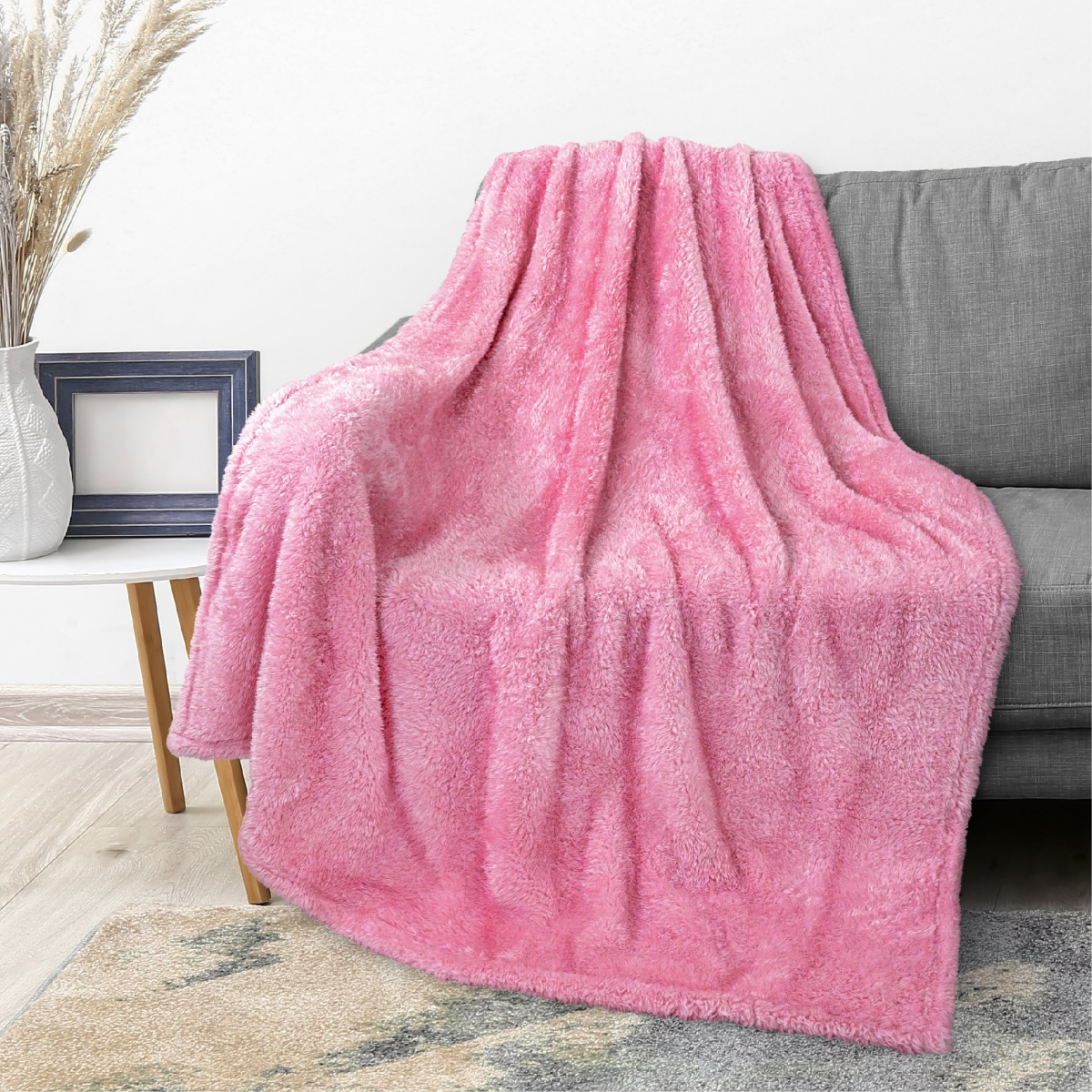pink velvet blanket on gray couch