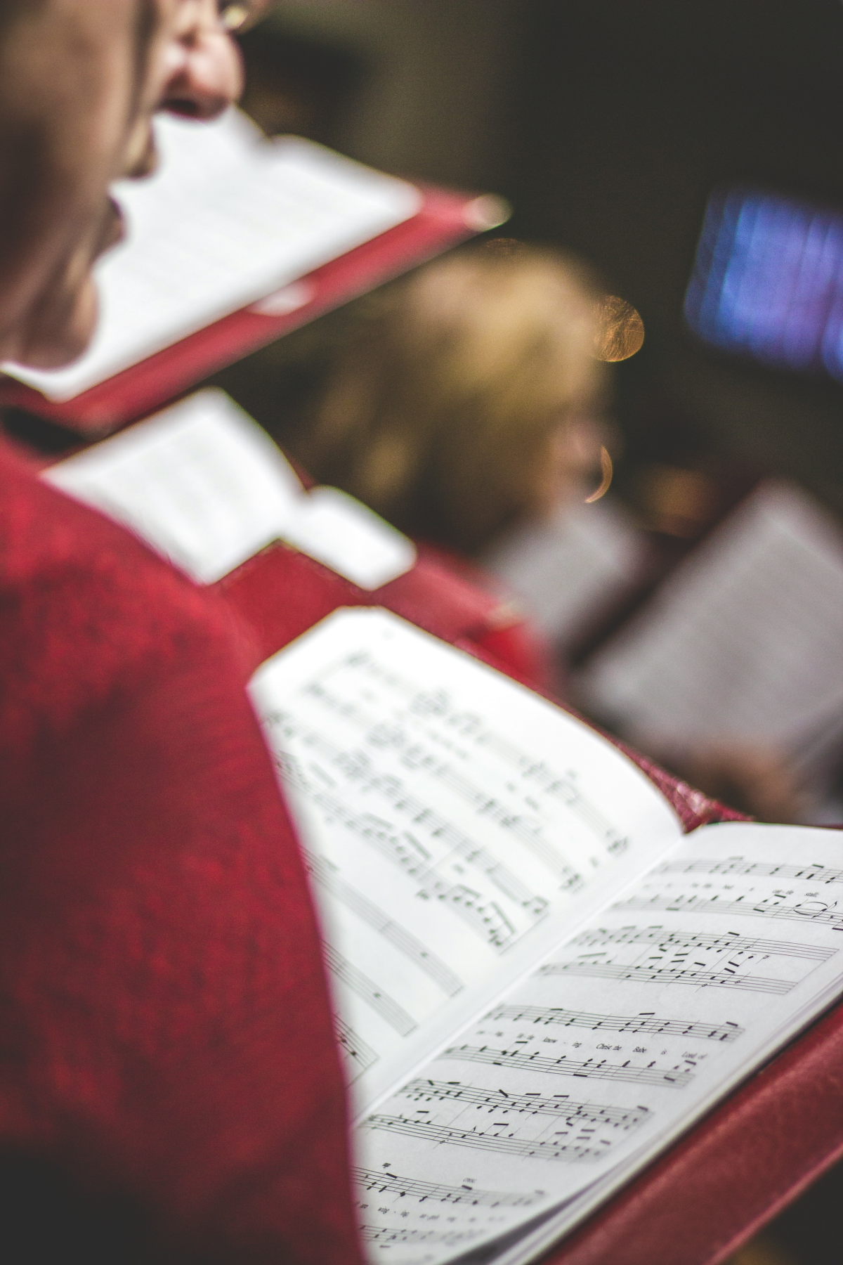 the twelve days of christmas people singing from song sheet