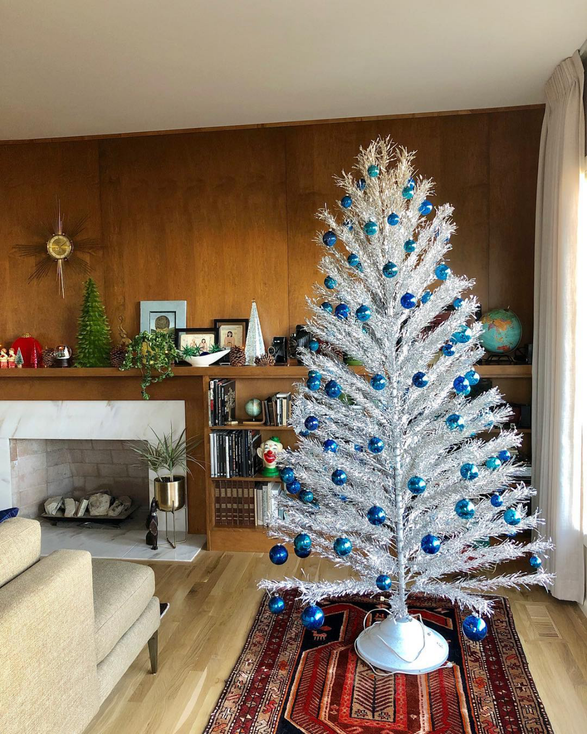 themed blue ornaments on aluminum tree