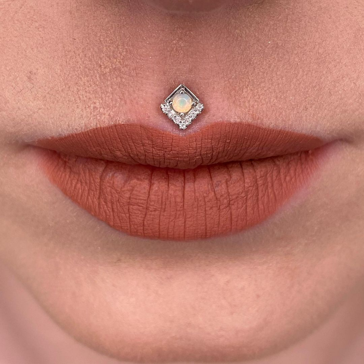 11 gemstone piercing above lip
