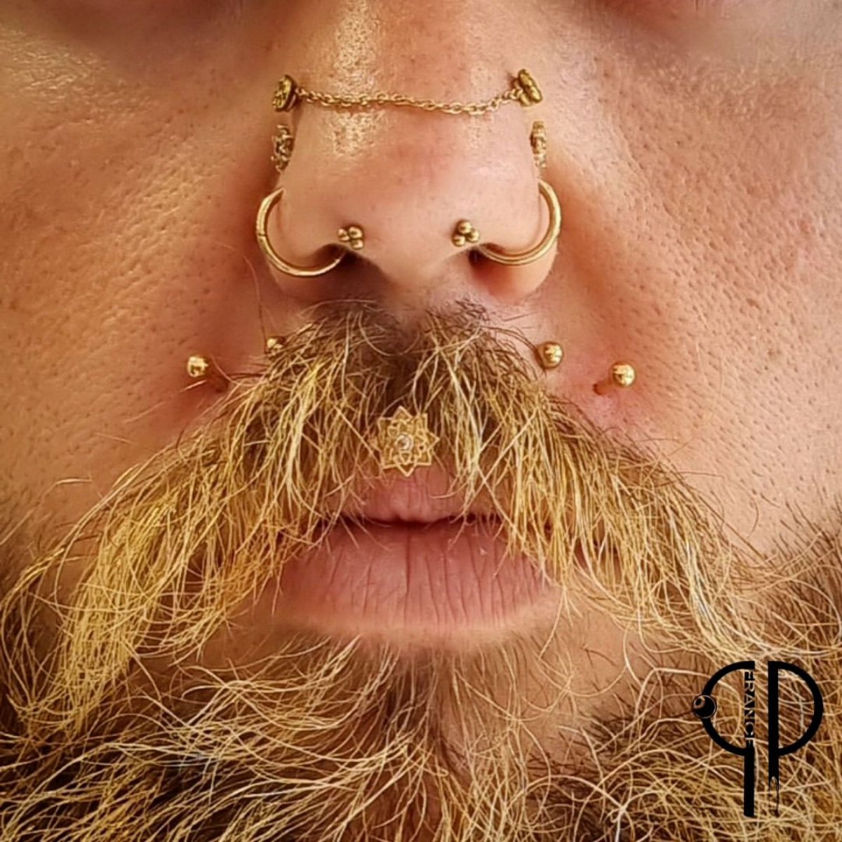 14 gold themed mouth and nose piercings