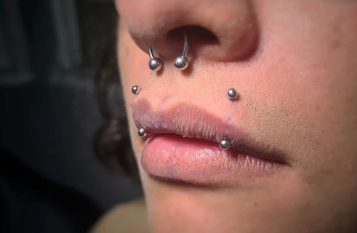 2 angel bites piercings person with studs angel bites