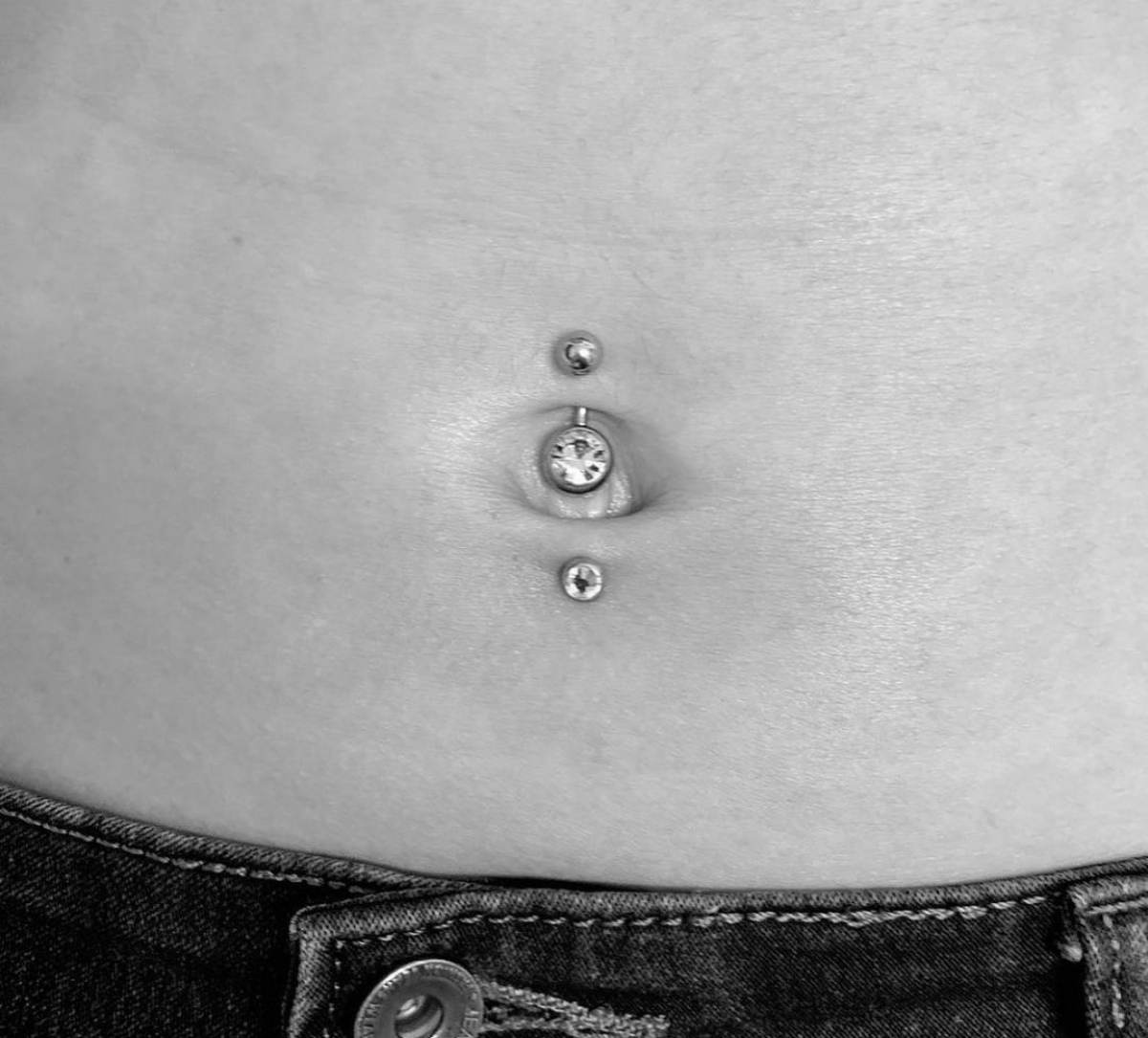 4 black and white photo of belly button piercing