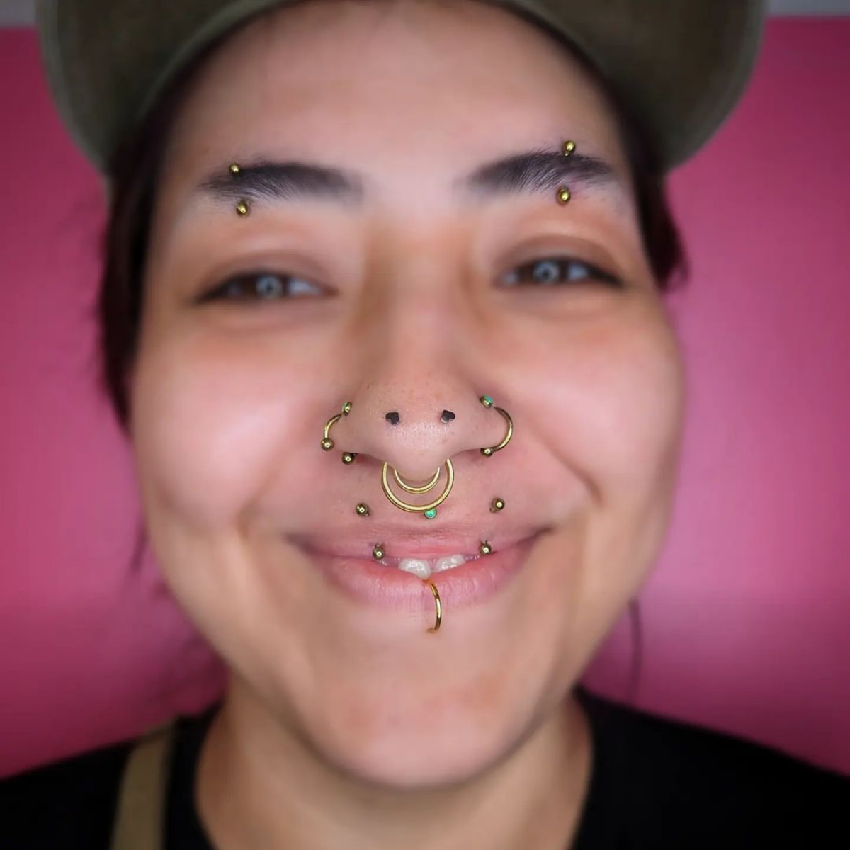 8 woman with multiple face piercings