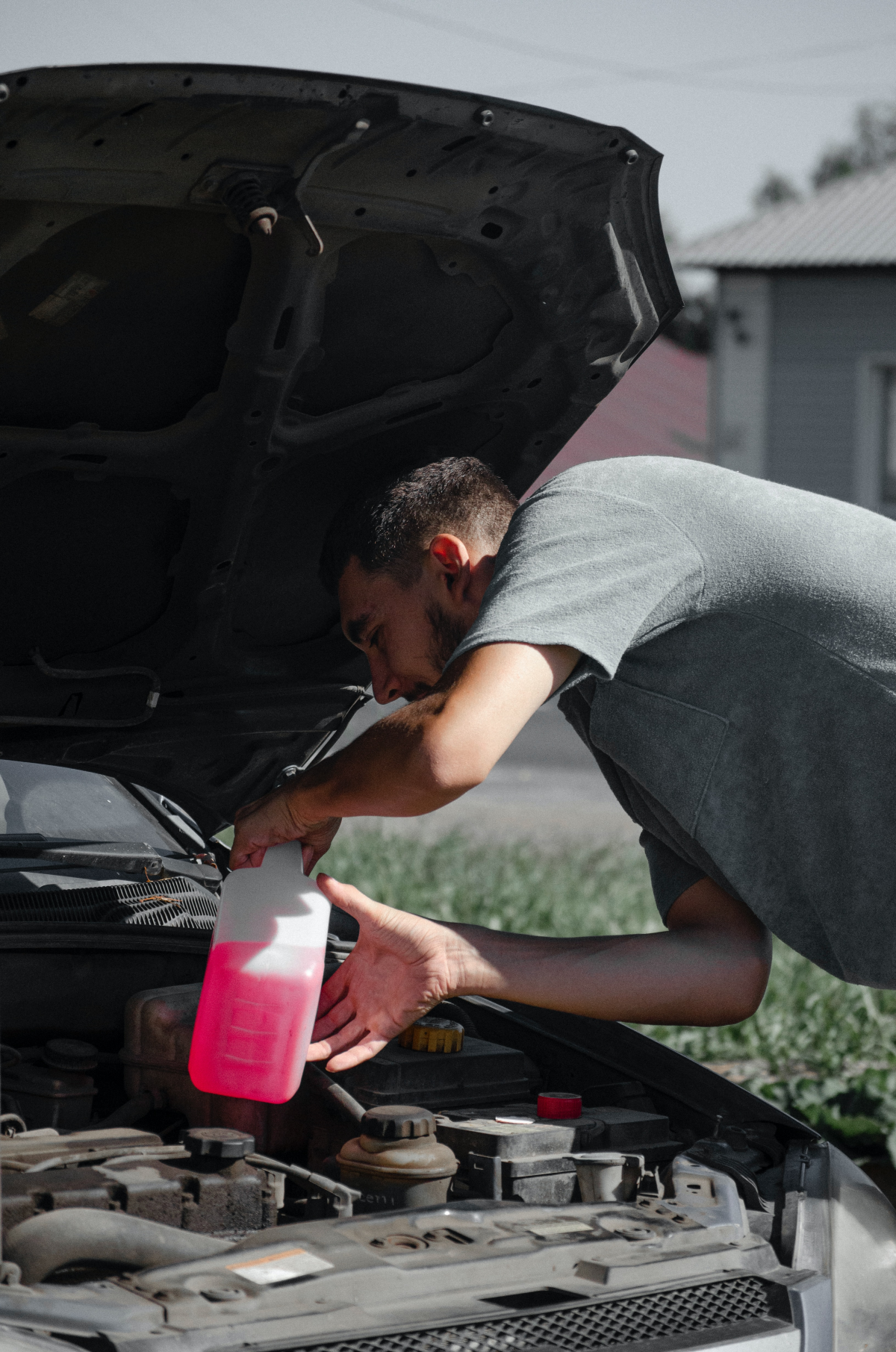 person using antifreeze in car