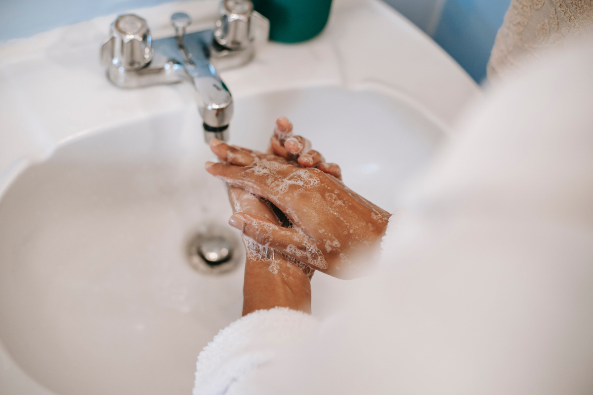 person washing hands with soap