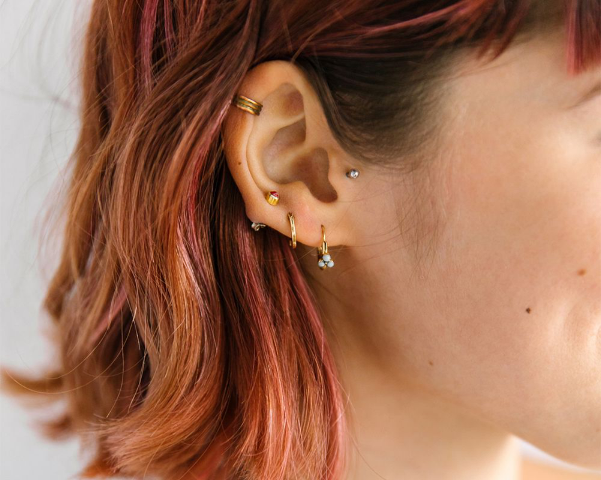tragus piercing woman with ear piercing