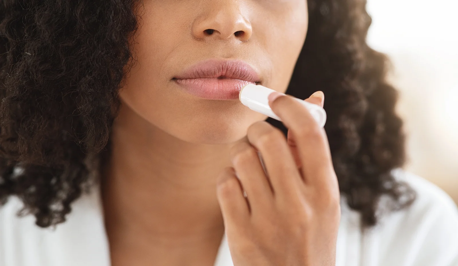 woman applying chapstick