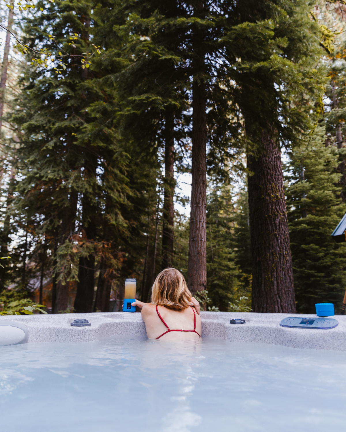 woman in hot tub in forest