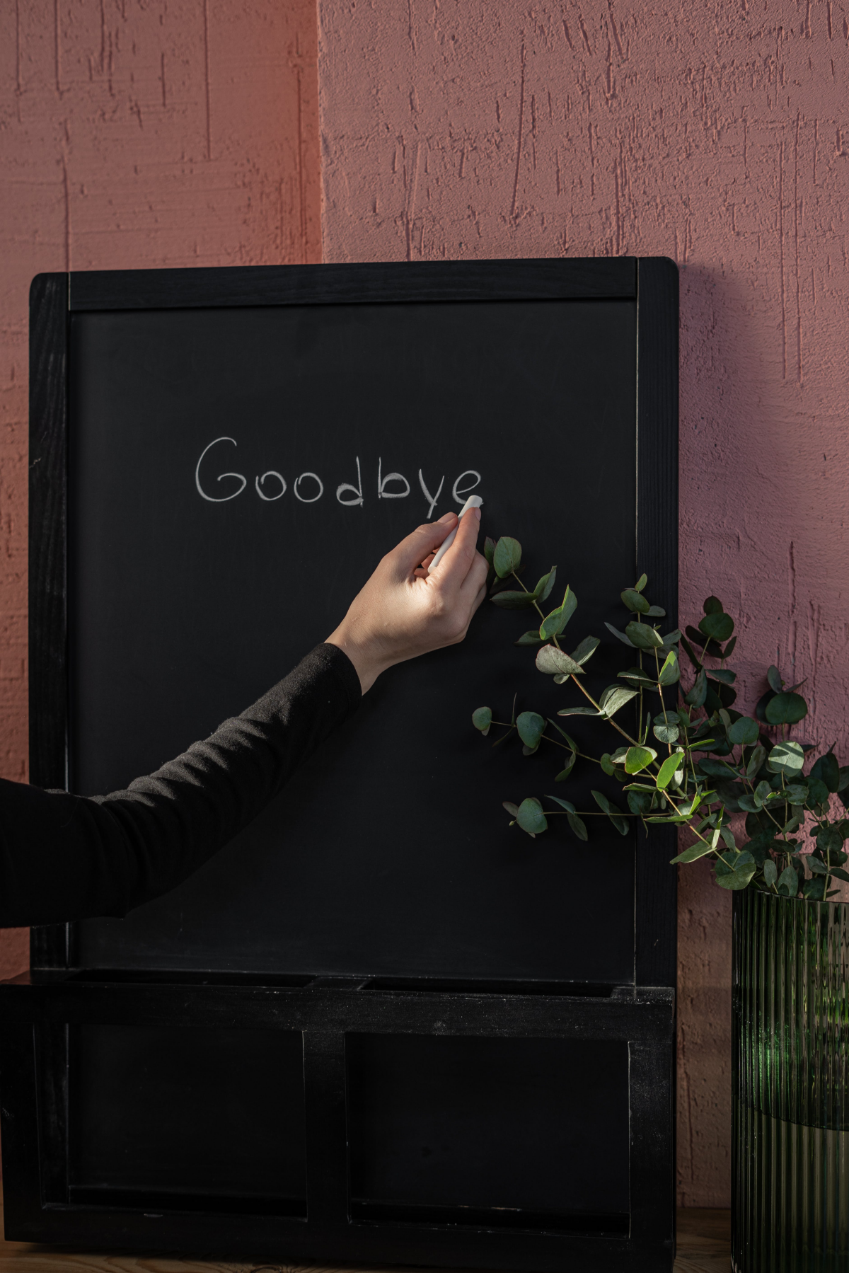 writing goodbye on chalkboard