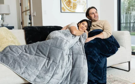 benefits of a weighted blanket couple snuggling on couch with blankets