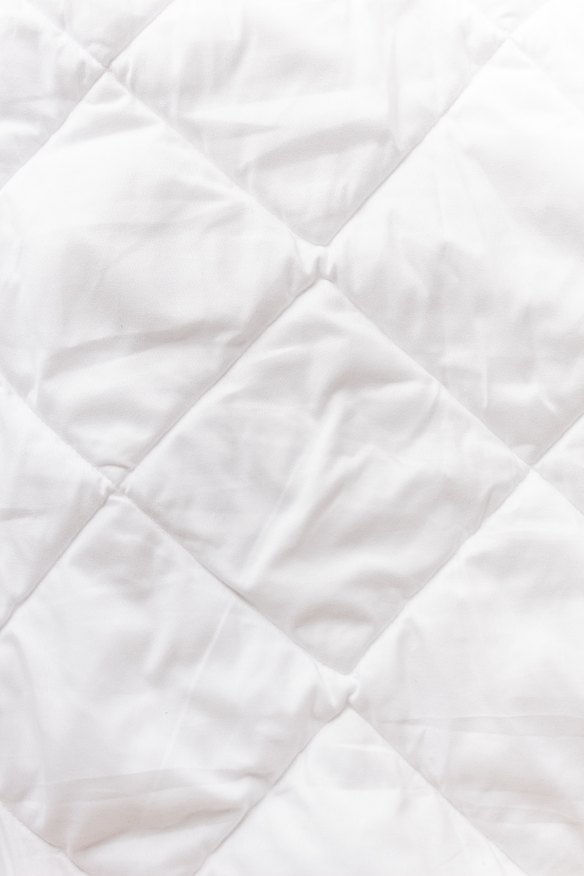 benefits of a weighted blanket white comforter in squares