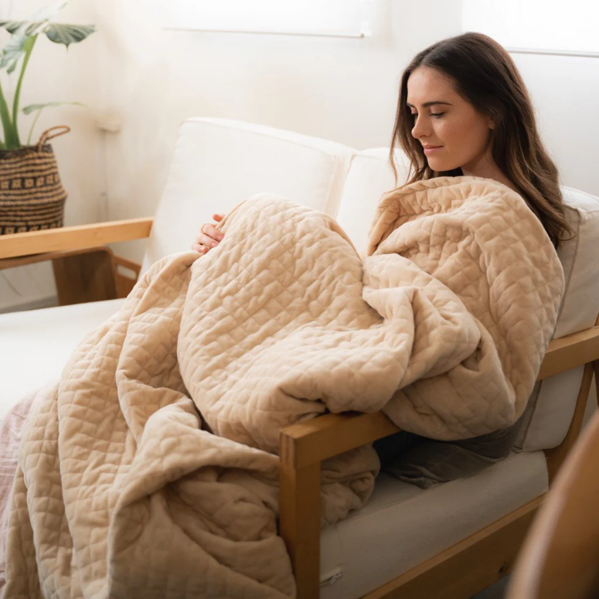 benefits of a weighted blanket woman under a weighted blanket