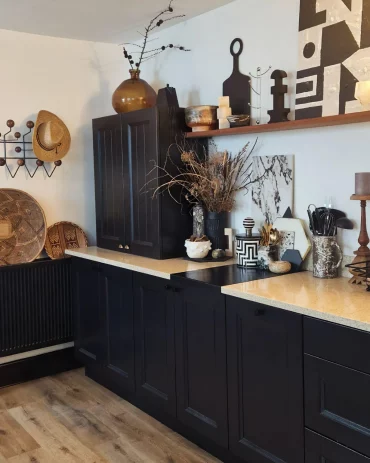 black cabinets in kitchen with wooden countertop
