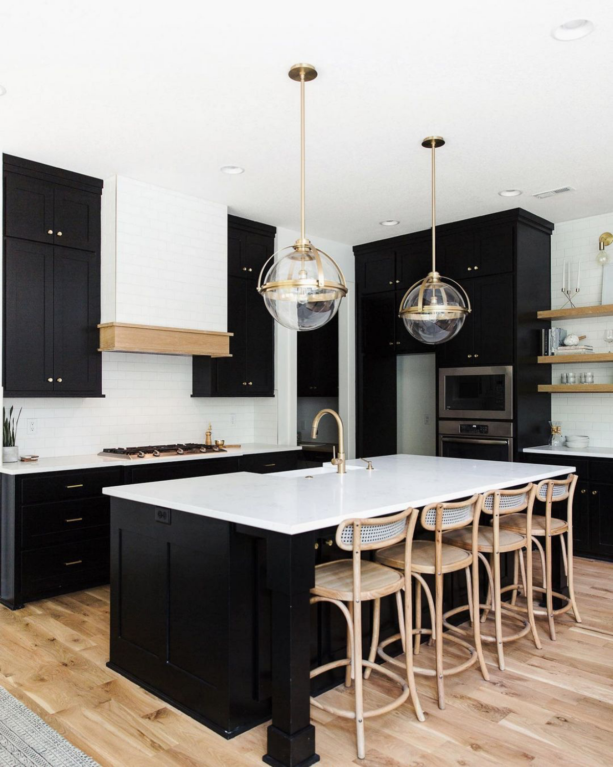 black kitchen with white countertops