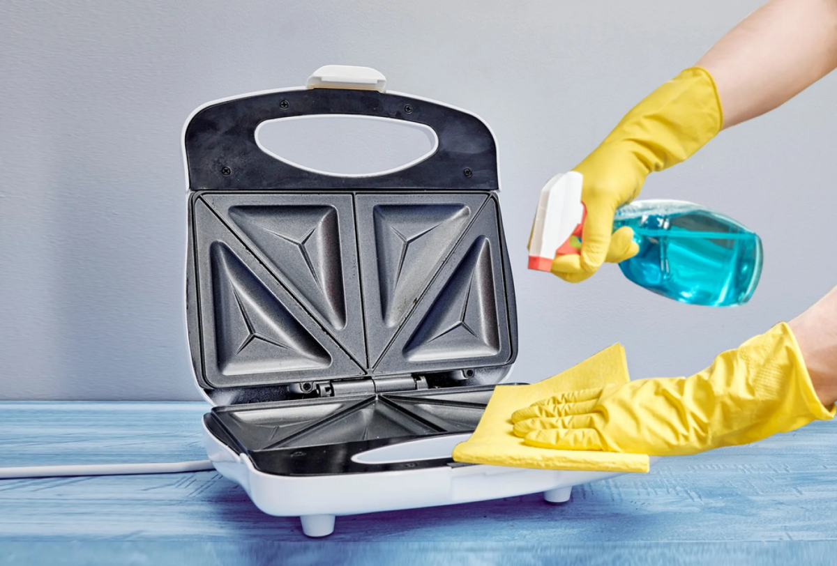 how to clean a panini press person cleaning panini press