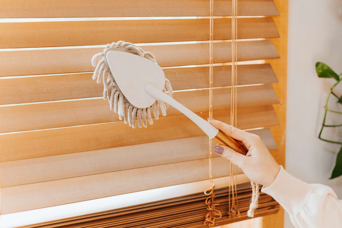 how to clean wooden blinds person cleaning wooden blinds