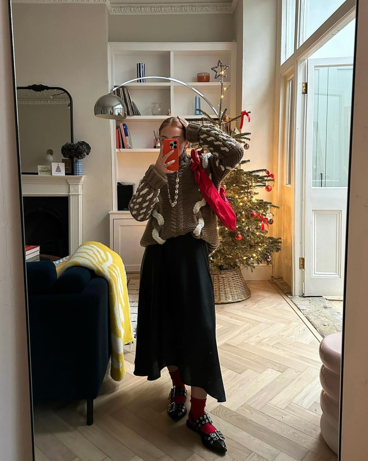 long black skirt and sweater and red bag