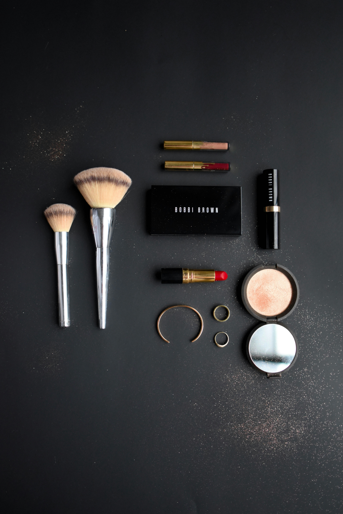 makeup essentials on black background