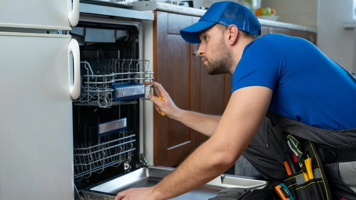 man looking at dishwasher