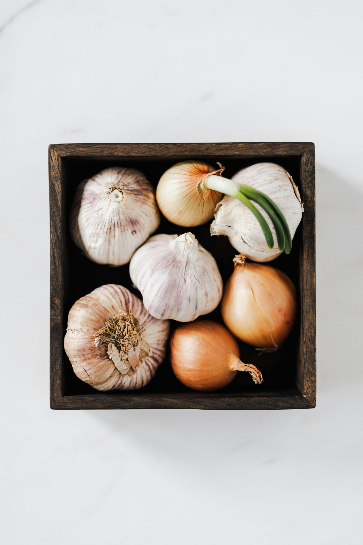 onions and garlic in a box