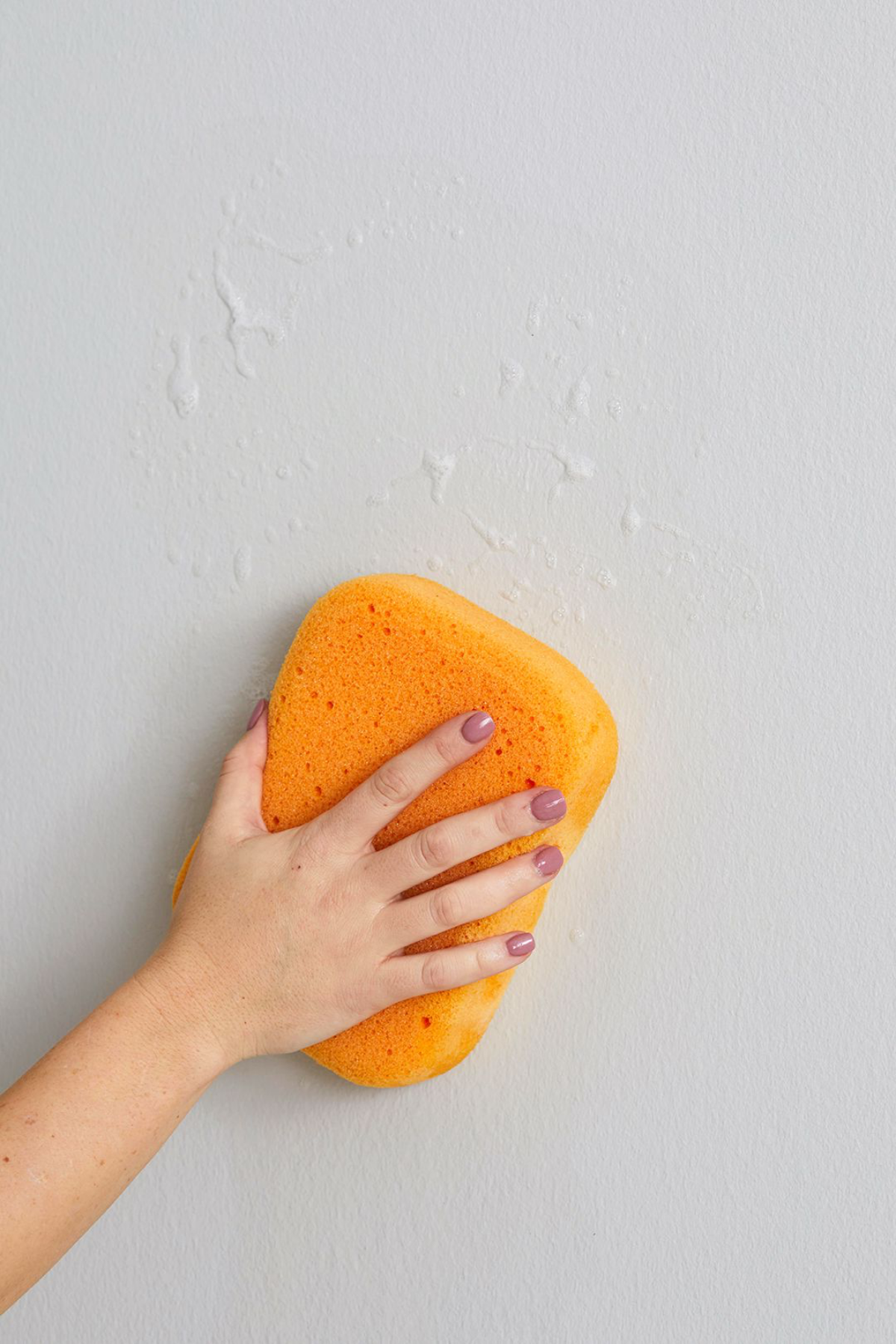 scrubbing walls with sponge