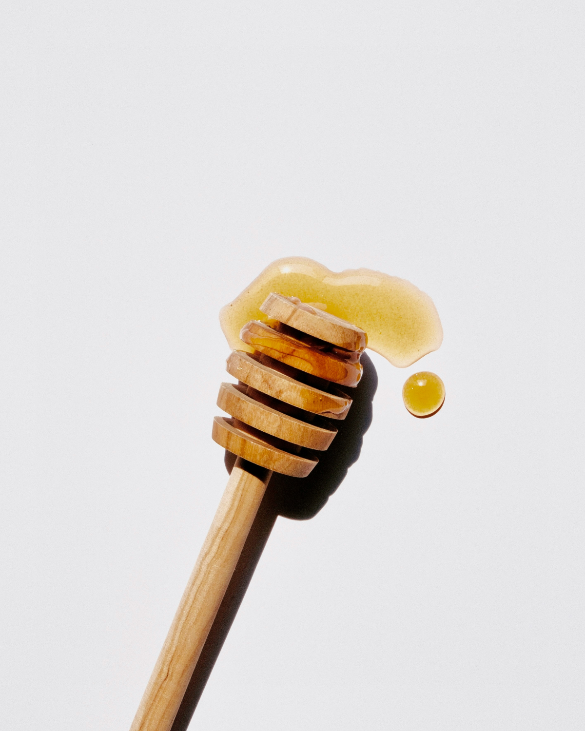wasp trap honey on a wooden spoon