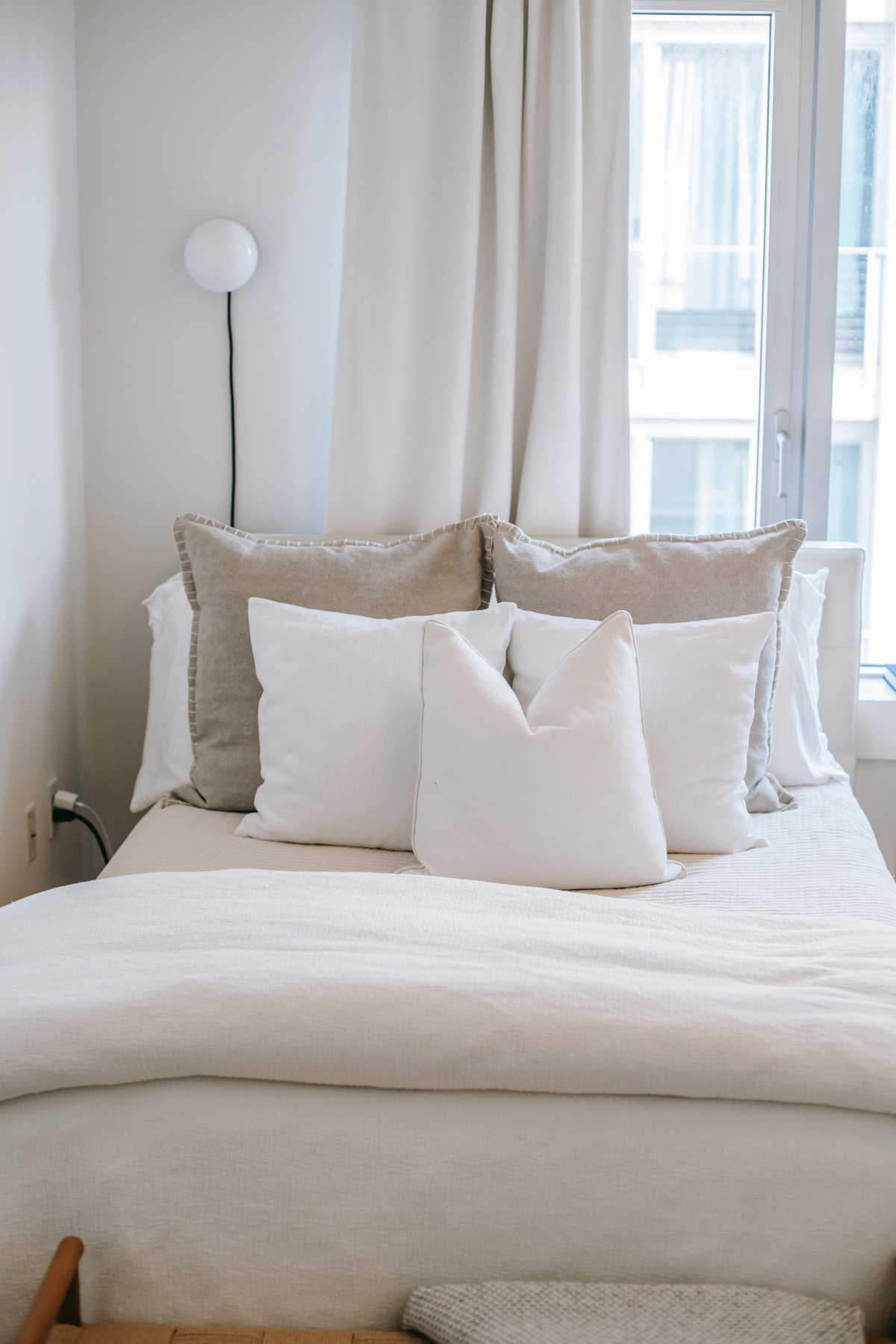 white bed with many pillows