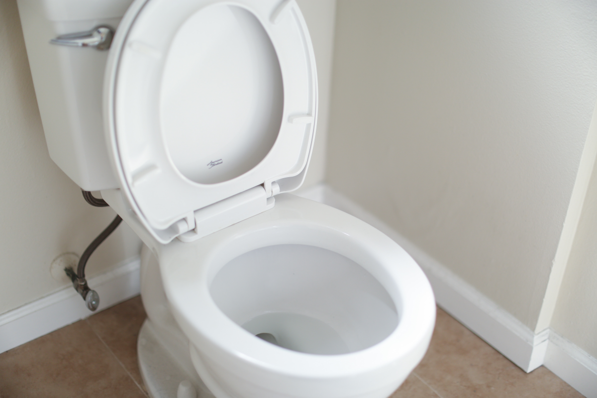 white toilet with open lid