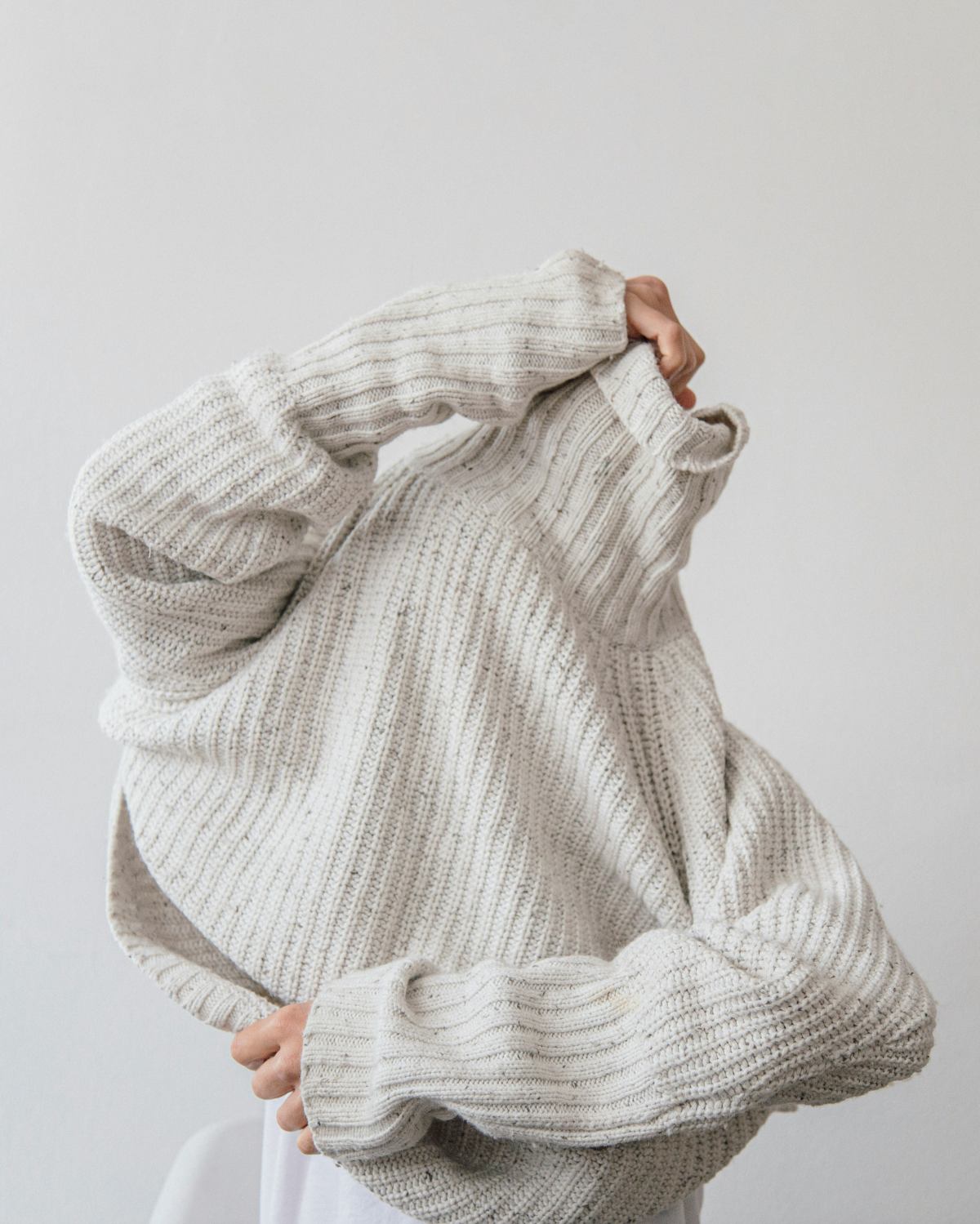 woman pulling off her sweater