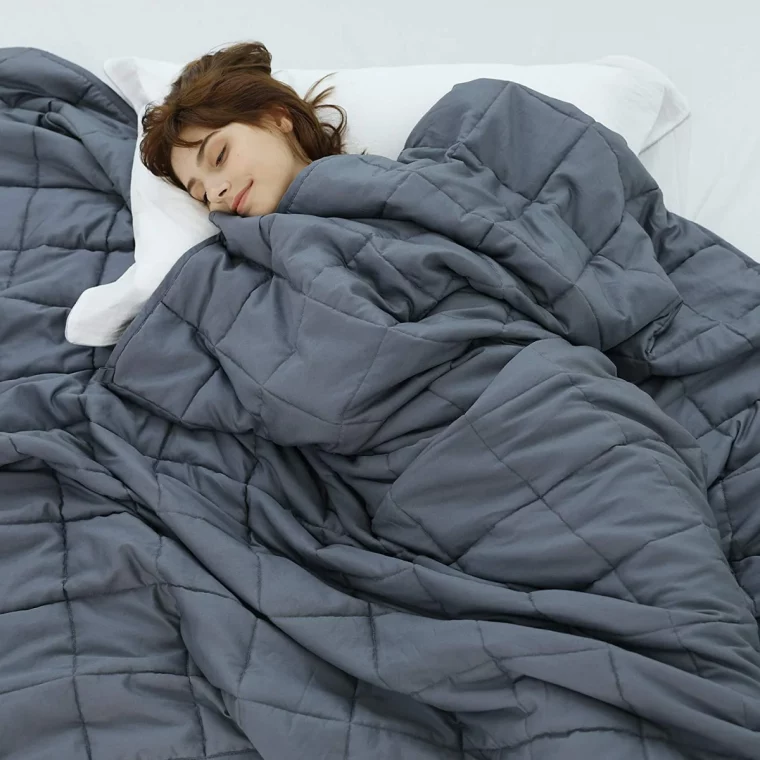 woman sleeping under weighted blanket