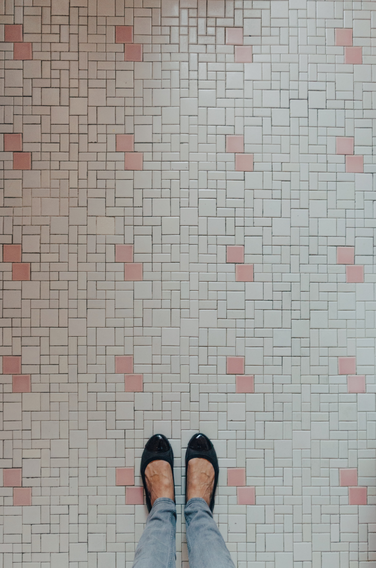 woman stepping on small tiles