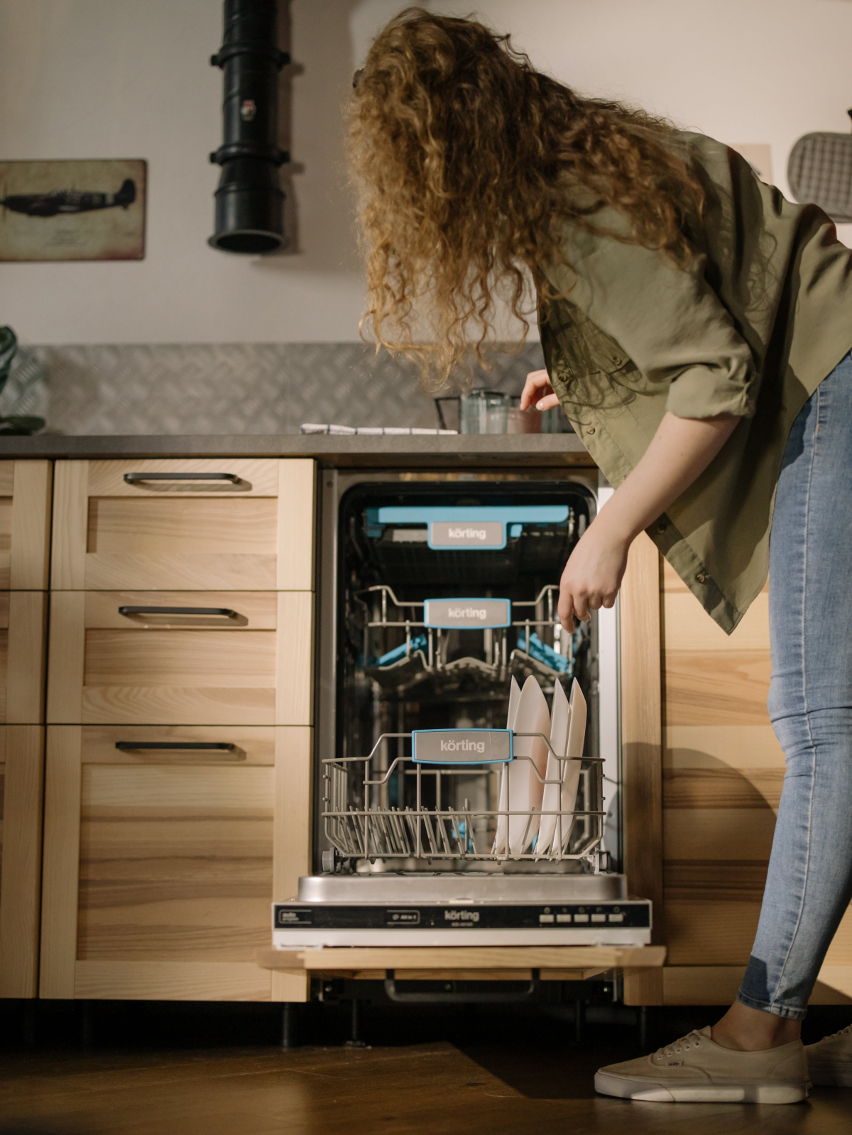 woman using a dishwasher