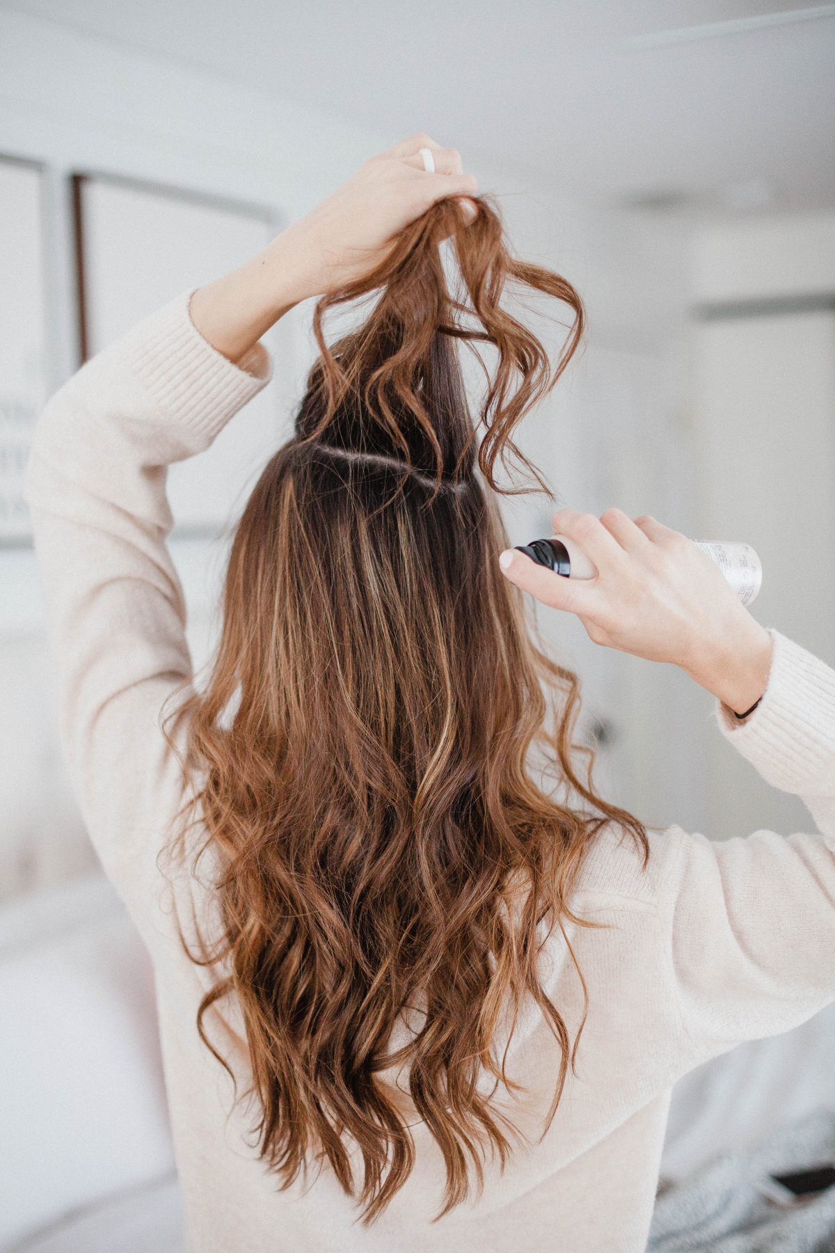 woman using dry shampoo on hair