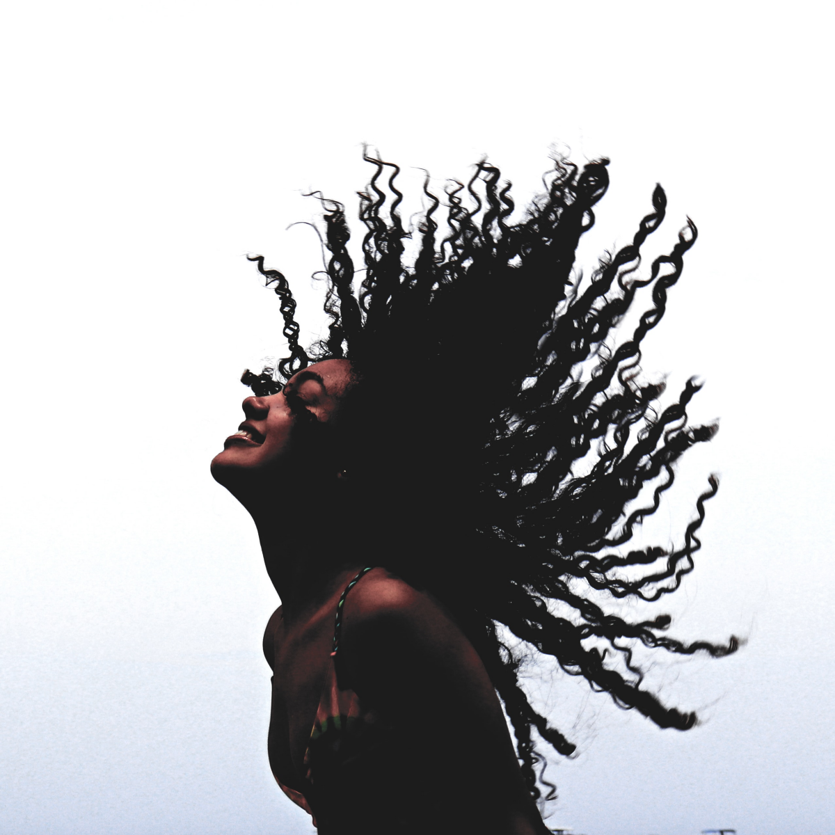 woman waving around her curly hair