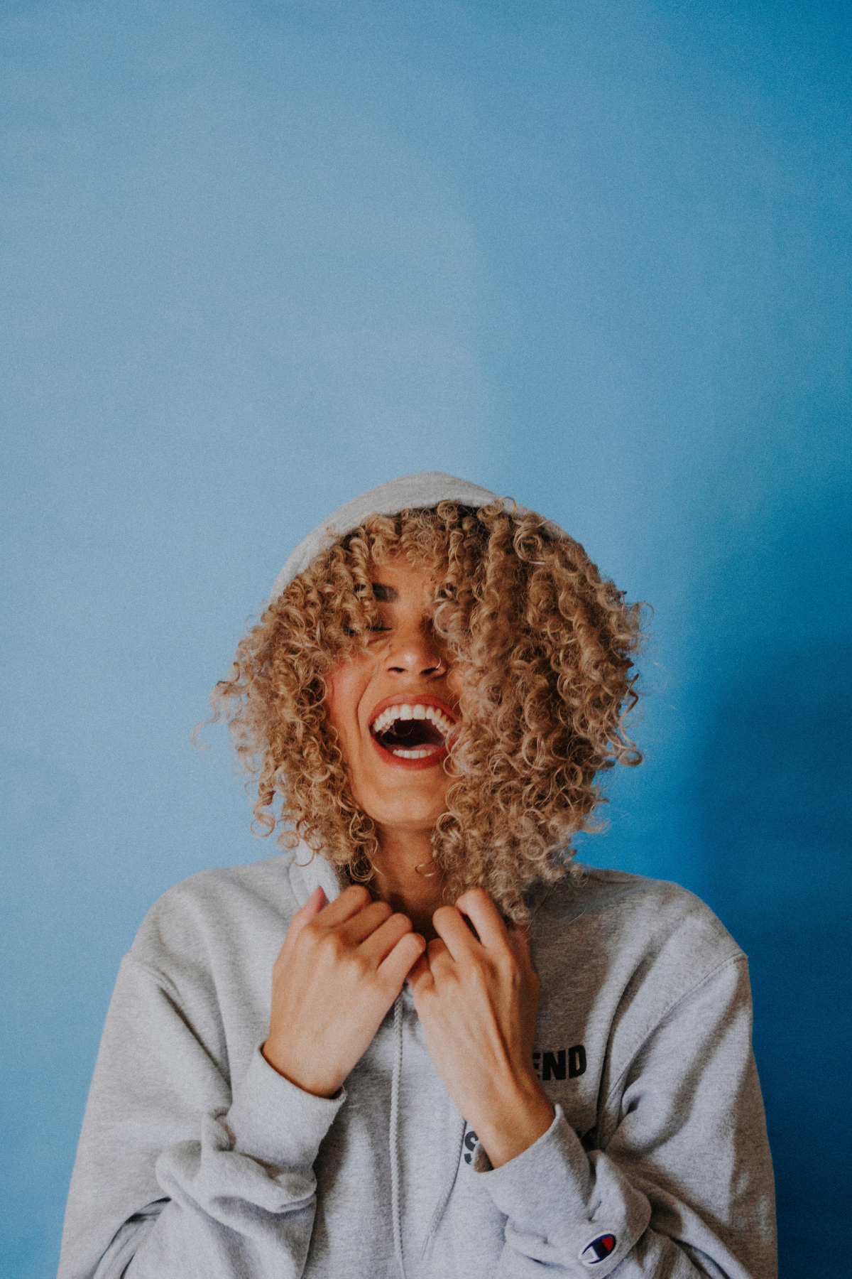 woman with curls laughing