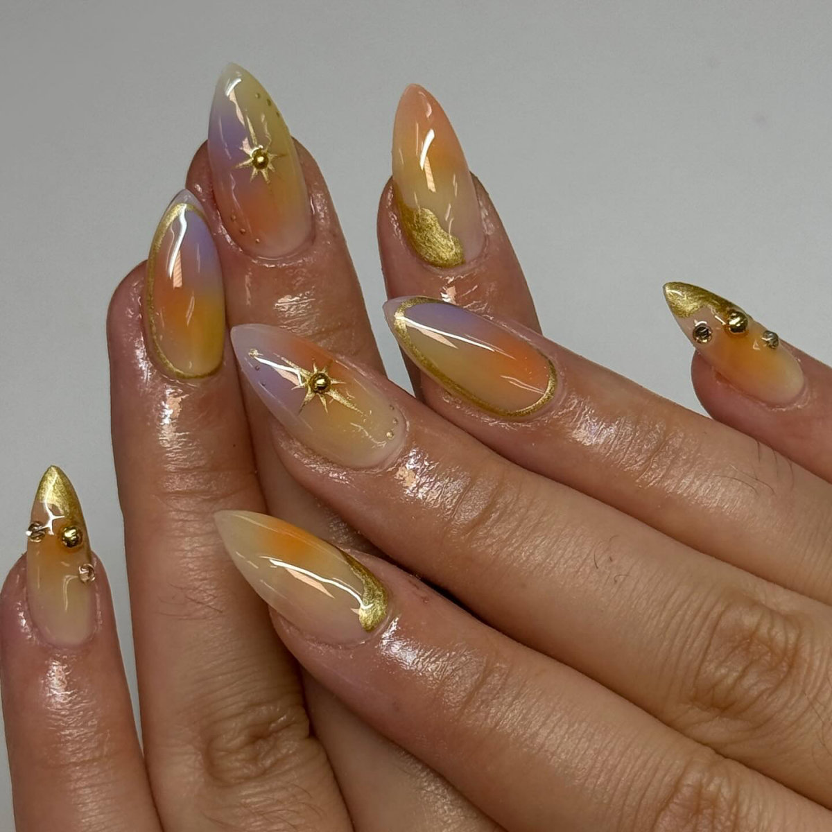 aura airbrush nails with golden accents
