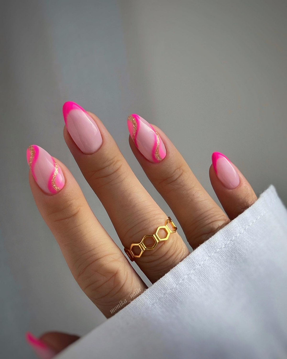 barbie pink nails with gold swirls