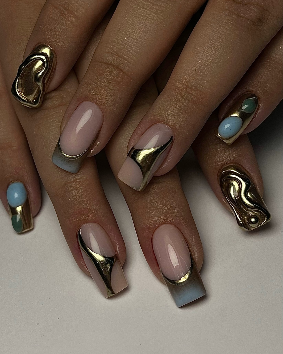 blue gold and neutral nails with chrome golden finish