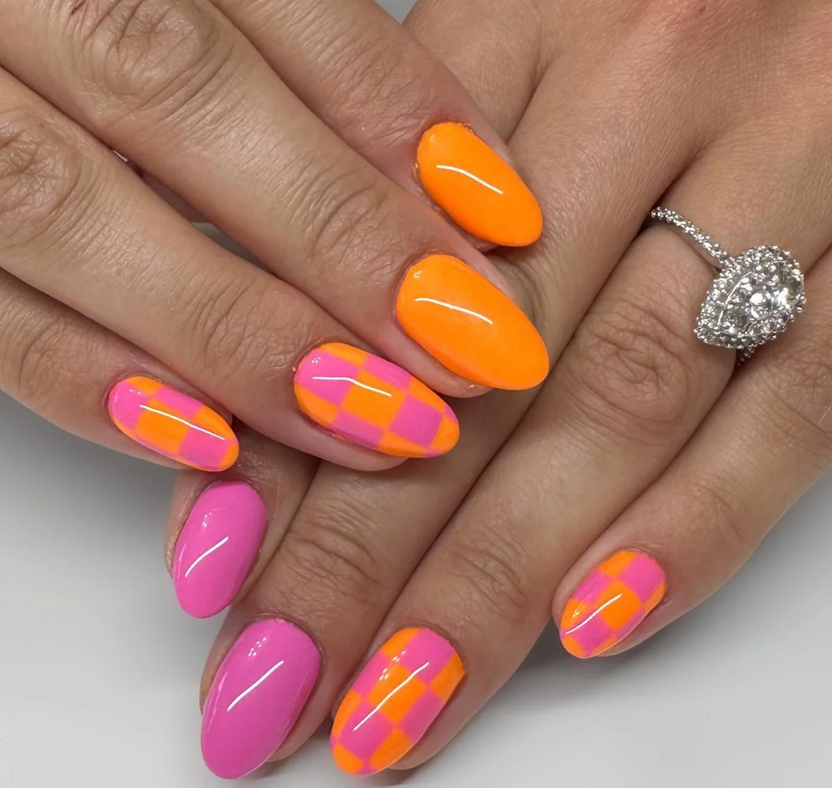 checkered nails in pink and orange