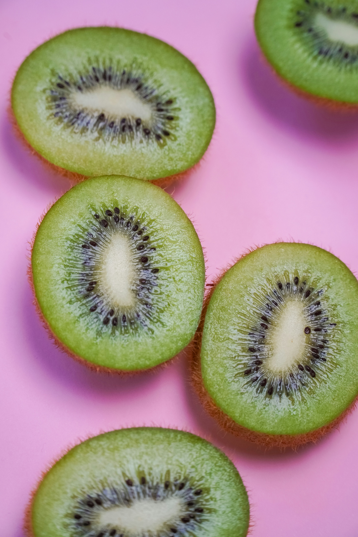 green fruit kiwi on pink background