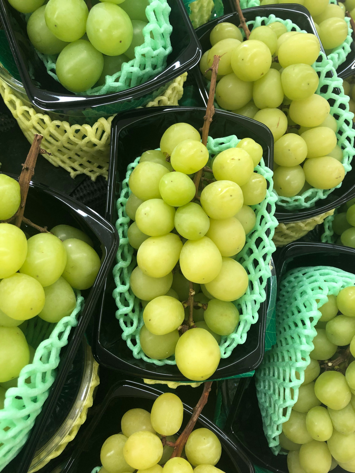 green grapes in different containers