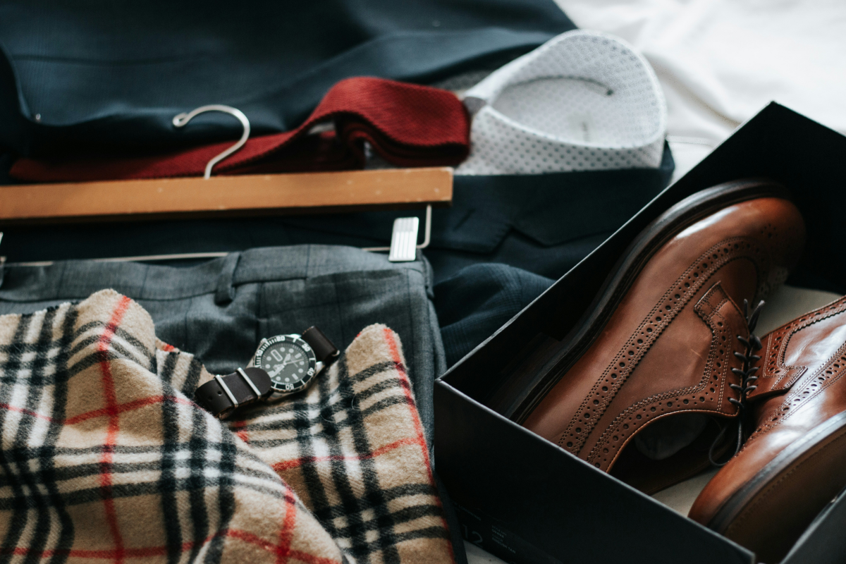 how to pack a suit in a suitcase suit and shoes and tie on bed