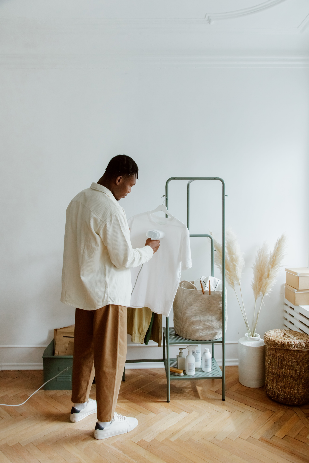 man steam ironing his shirt