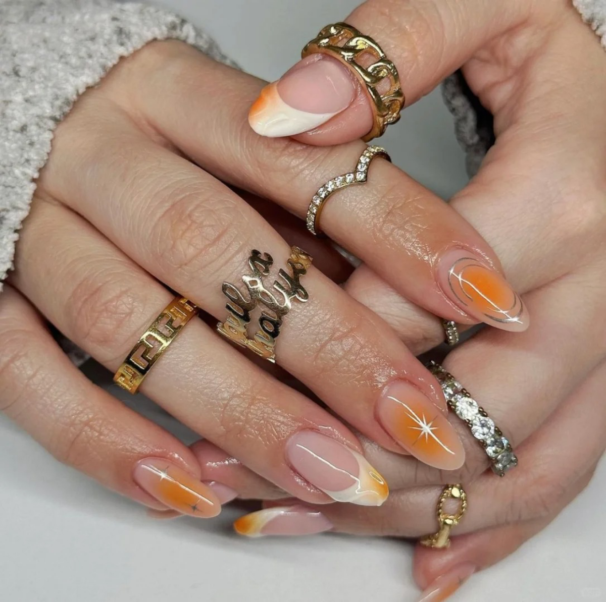 orange chrome nails shooting star design