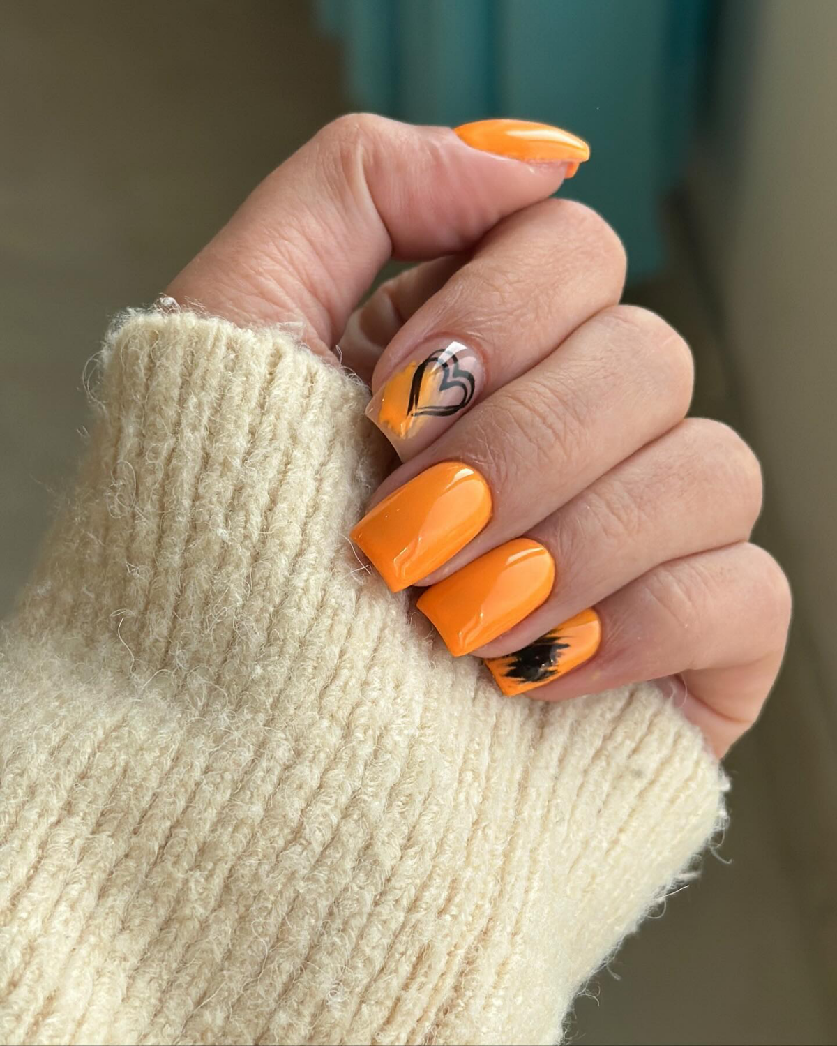 orange nails with black heart