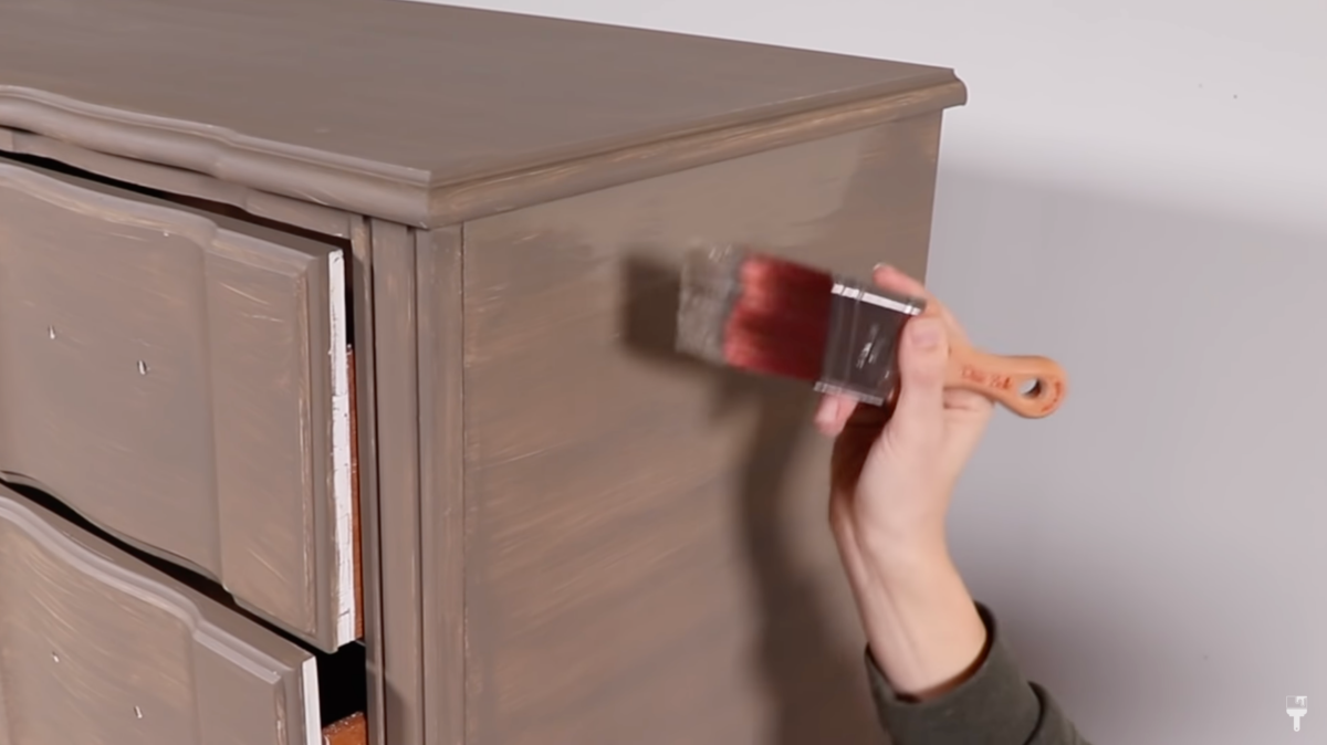 person painting furniture