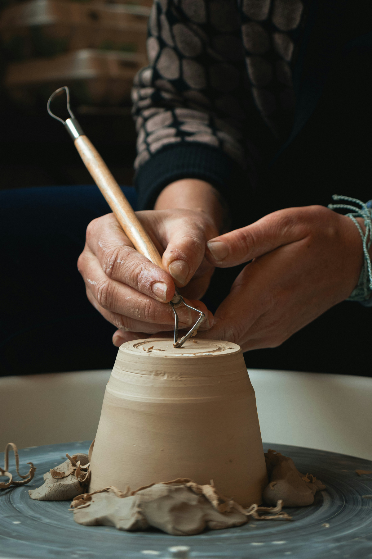 person working on pottery